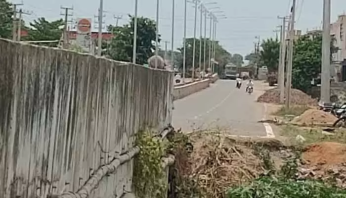Despite completion, the Mellacheruvu–Revuru four-lane road lacks warning signs at a key bridge, creating danger for motorists.